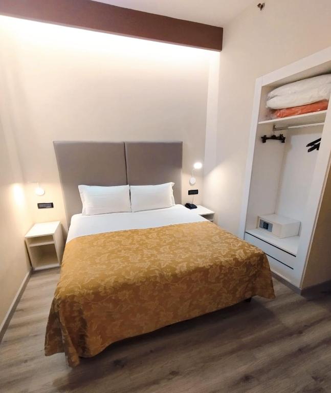 a bedroom with a large bed and a closet at Hotel Continental in Turin