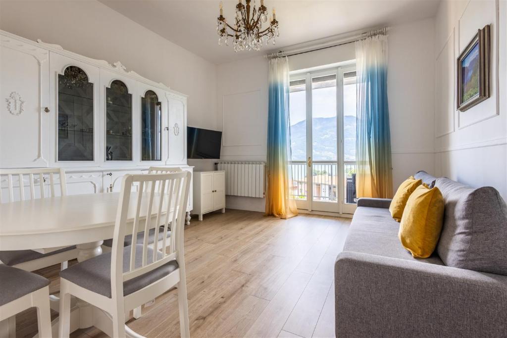 a living room with a table and a couch at IseoLakeRental - Casa Massimo in Lovere