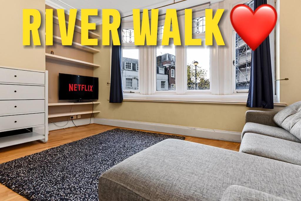 a living room with a river walk sign in the window at Charming Modern 1bedroomFlat in the Heart Richmond in Richmond