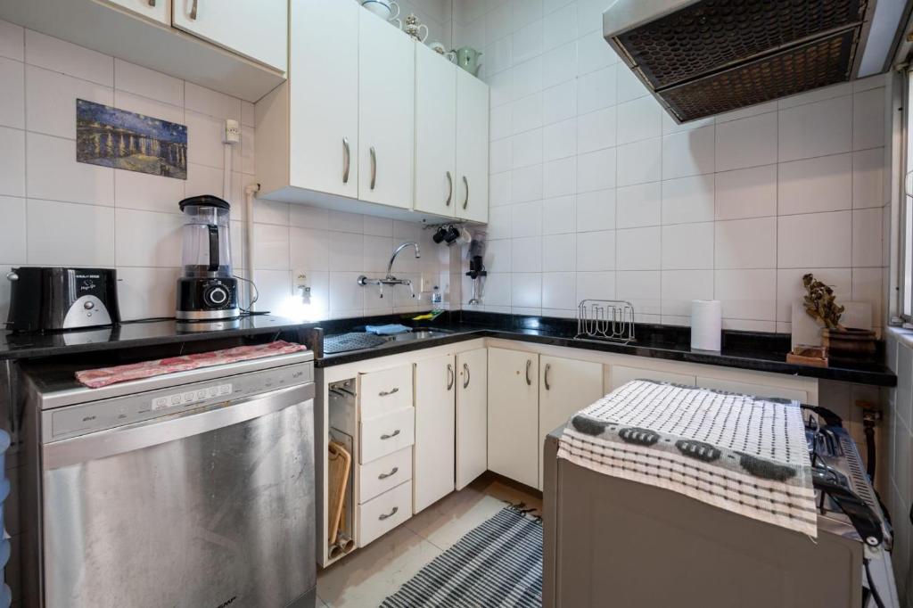 a kitchen with white cabinets and a dishwasher at 2 quartos a 200m da Praia do Flamengo in Rio de Janeiro