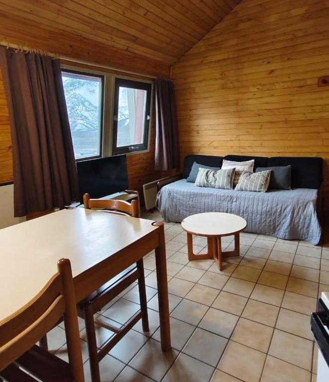 a living room with a bed and a table at Depto 5 pax, 2 baños, Cirrus 967 in Las Lenas
