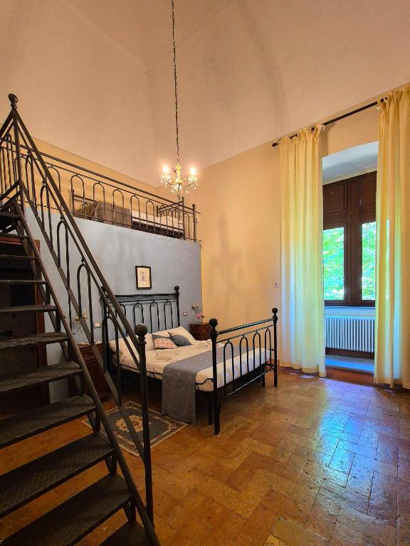 a bedroom with a bed and a staircase in it at Camera del Condottiero in Mercatello sul Metauro