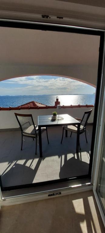 a view of a table and chairs on a balcony at Apartment Eva in Murter