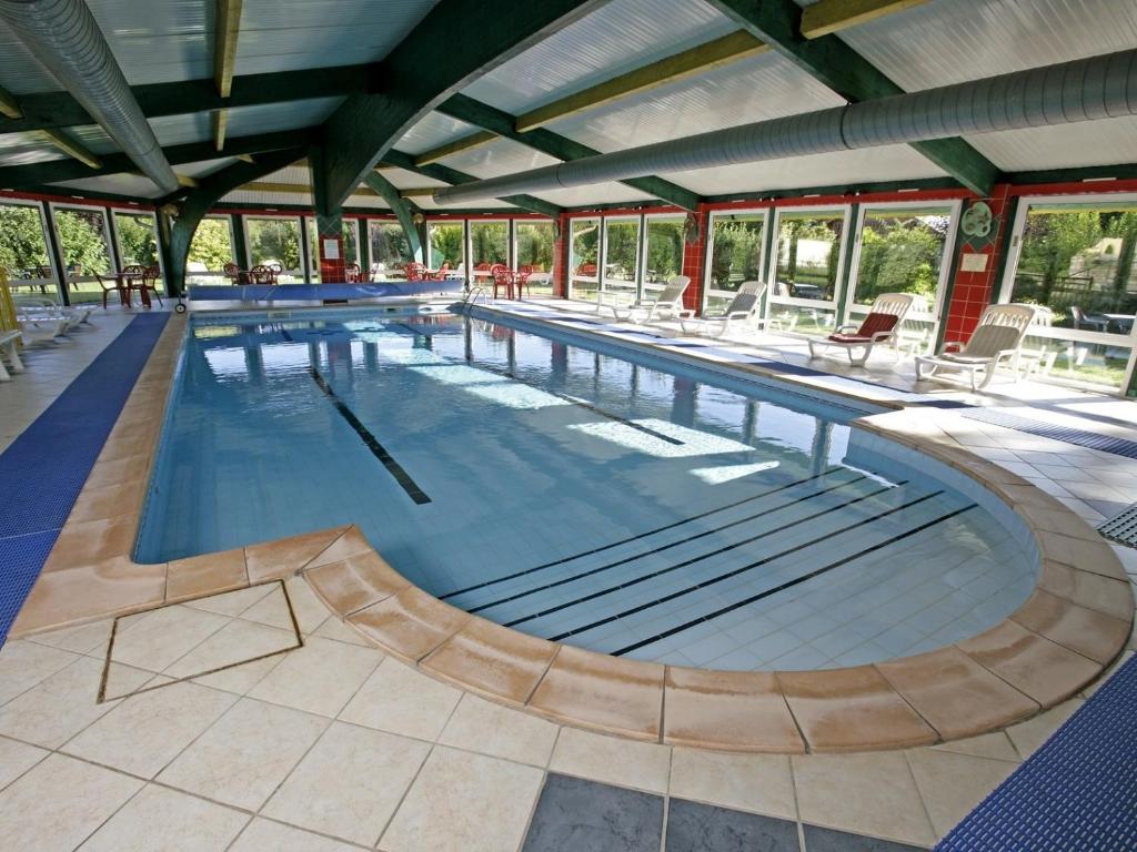 a large swimming pool in a large building at Chalet Résidence La Combeauté in Girmont-Val-dʼAjol