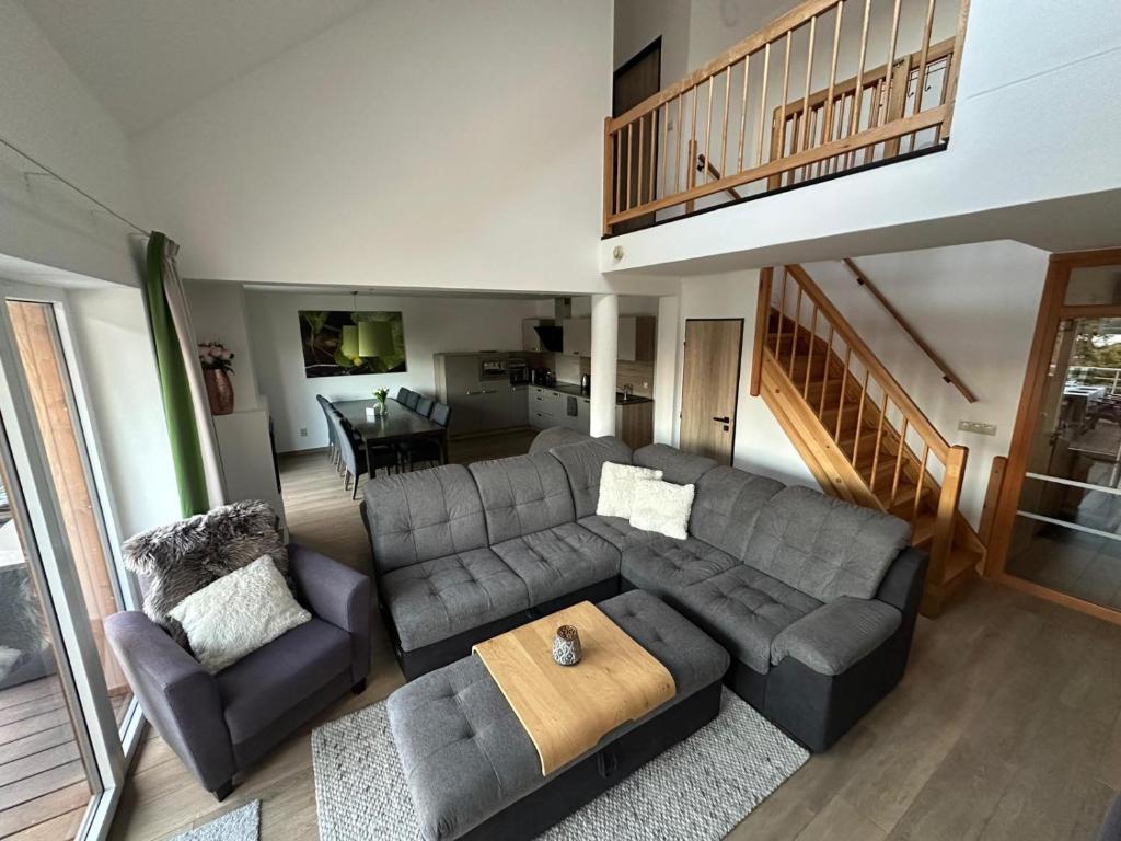 a living room with a couch and a table at SNOW LAKE Lipno in Lipno nad Vltavou
