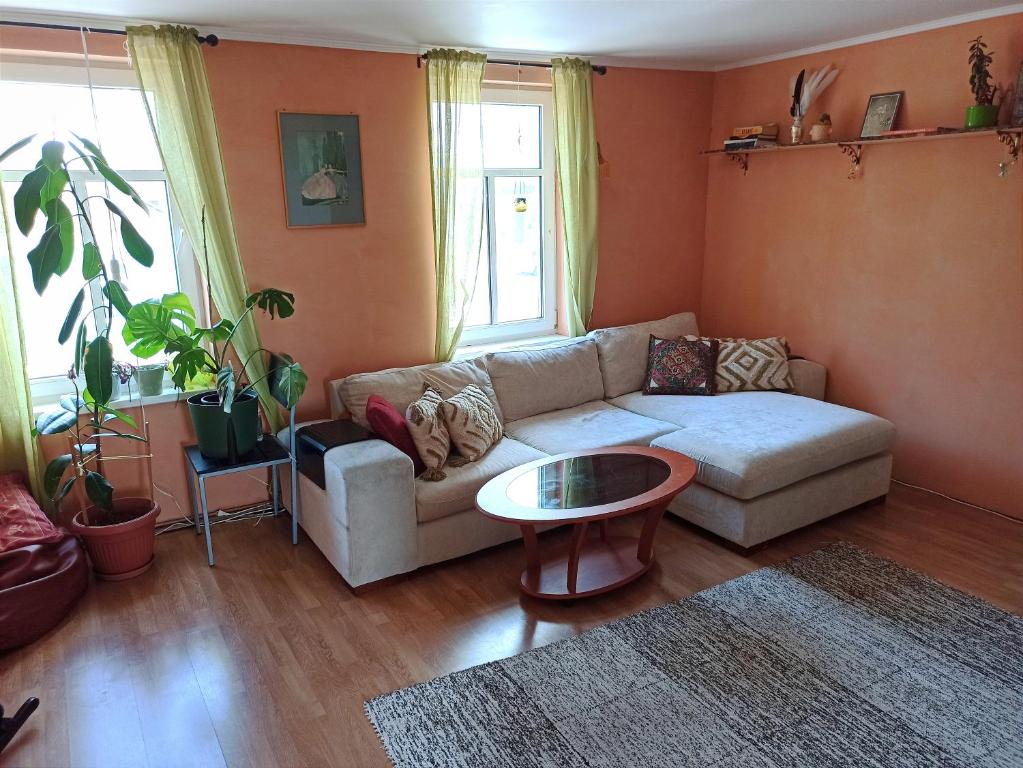 a living room with a couch and a table at Ruumikas looduslik pärl- Self check-in in Viljandi