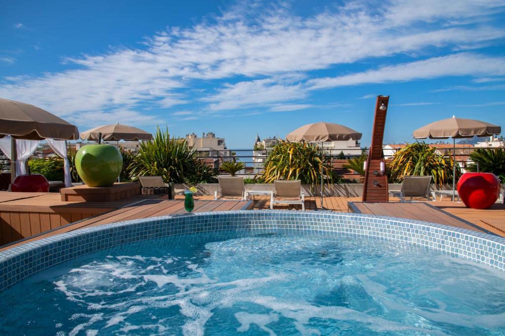 a swimming pool on the roof of a hotel at Best Western Premier Le Patio des Artistes Wellness Jacuzzi in Cannes