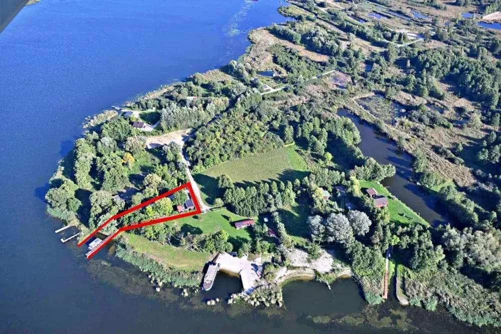 an aerial view of an island with trees and water at Domek nad Jeziorem - Wielkopolskie Mazury in Konin