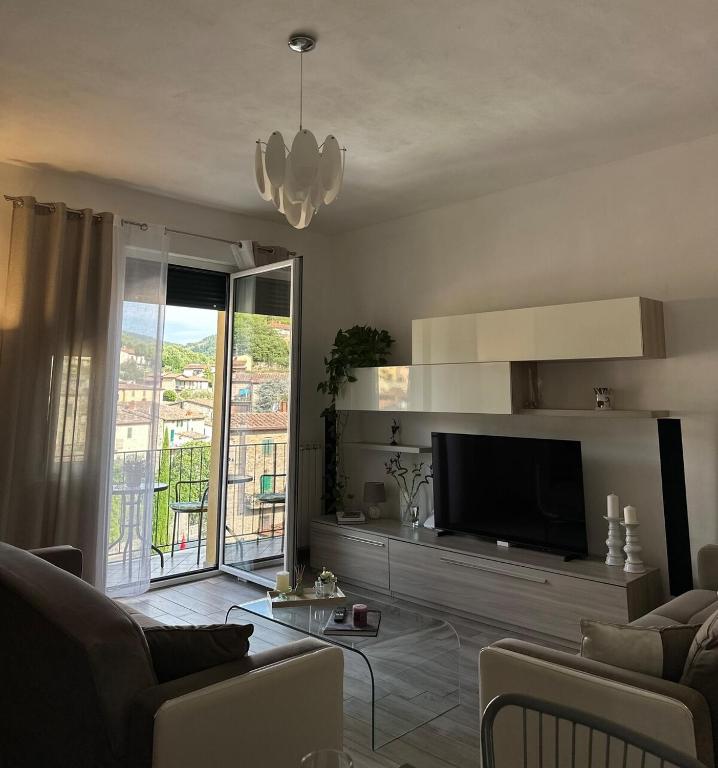a living room with a flat screen tv and a couch at Chianti Nest in Gaiole in Chianti