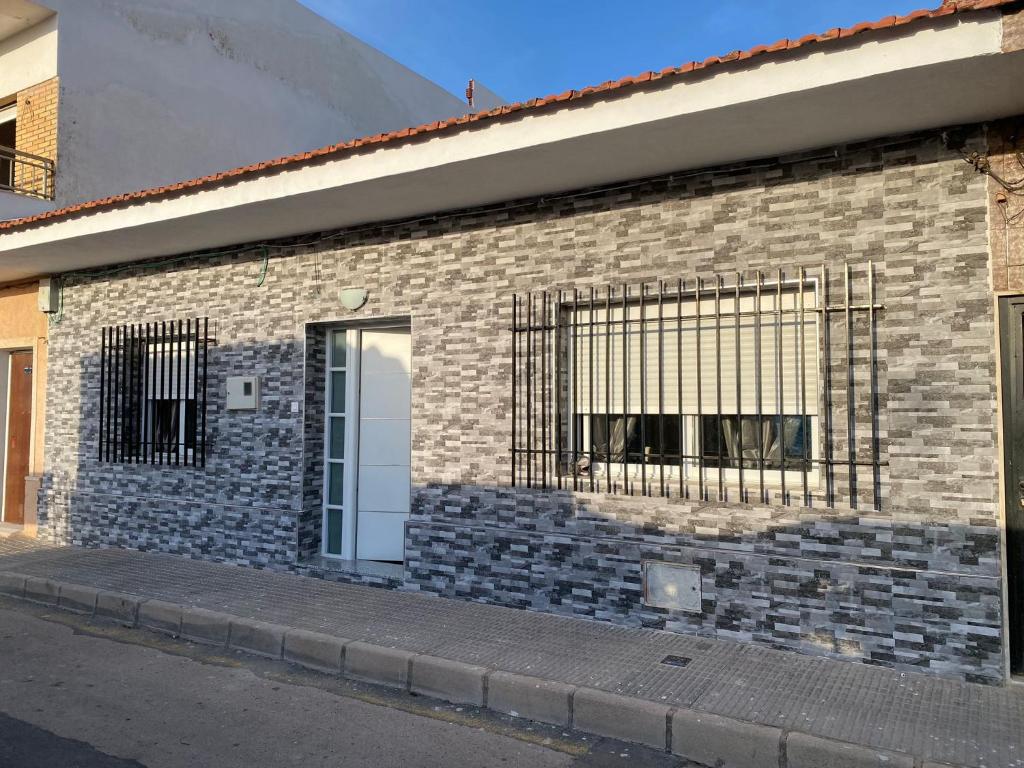 a brick building with a window with bars on it at Casa San Pedro in San Pedro del Pinatar