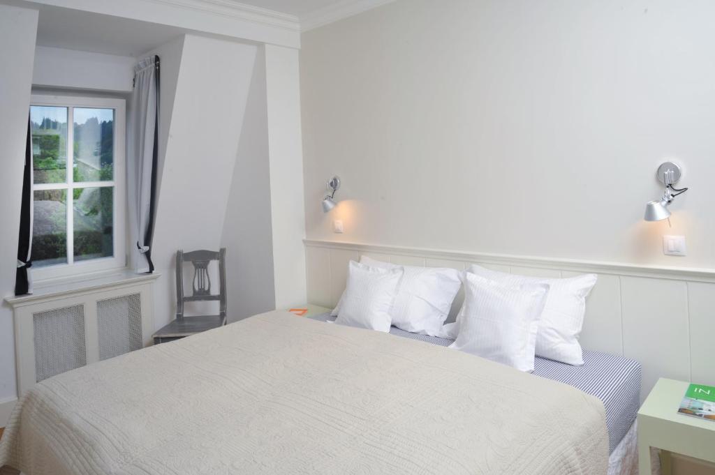 Postel nebo postele na pokoji v ubytování Galerie Suites