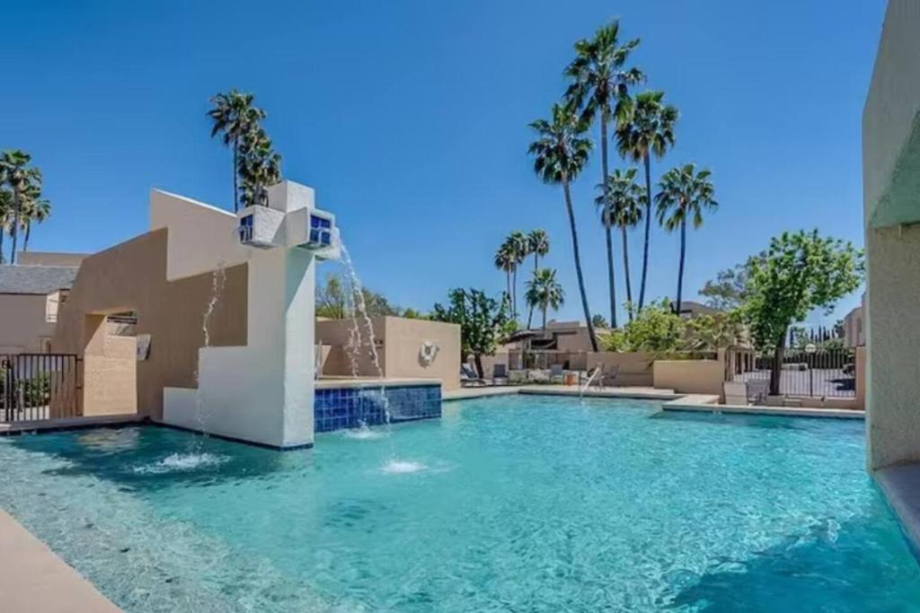 a swimming pool in a villa with palm trees at Sabino Canyon Condo with a Pool and Spa in Tucson