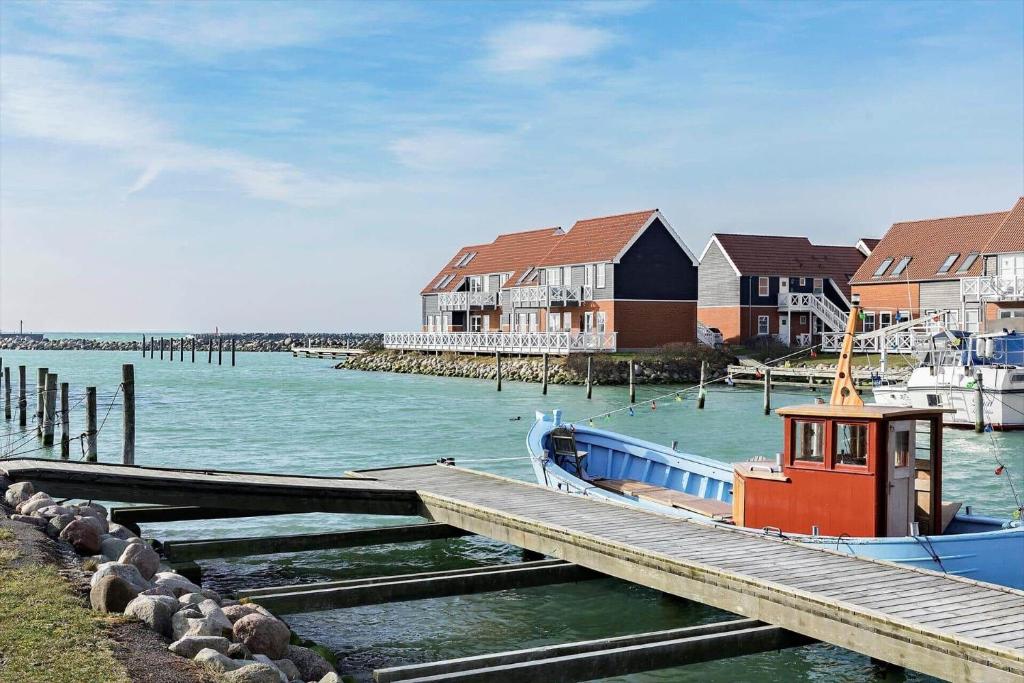 a boat is docked next to a dock at 4108-borre-Klintholm-havneby-8 in Borre