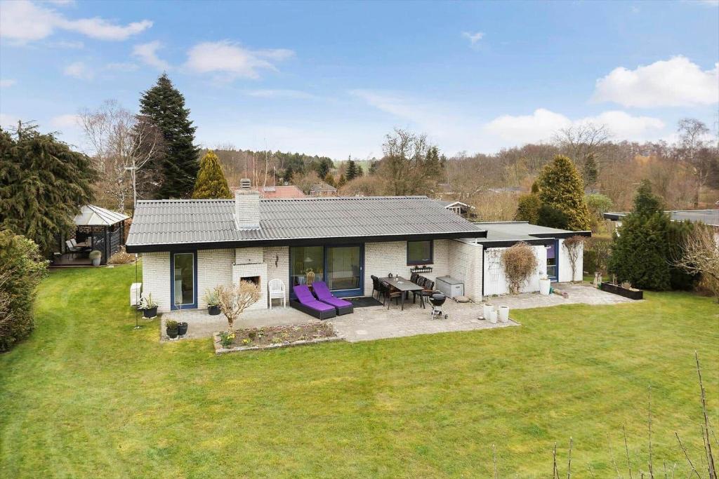 a house with a large yard with a table and chairs at 3076-Stege-Rusen-16 in Stege