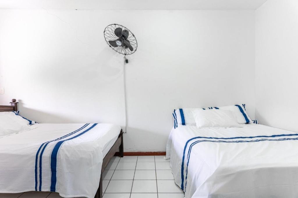 a room with two beds and a fan at Bela Casa com Piscina-5 Quartos-SH106D in Bezerros