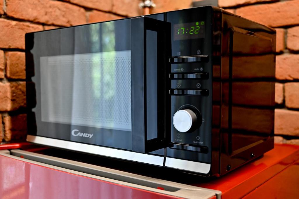 a microwave oven sitting on top of a counter at Apartman KOCKICA Entry with PIN 0-24h , Free parking in Slavonski Brod