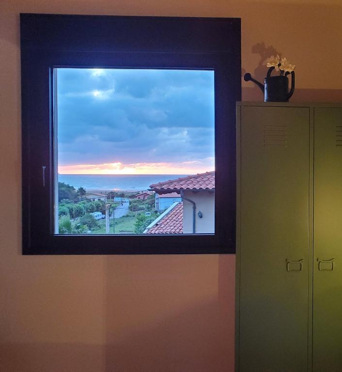 a window in a room with a view of the ocean at MC Vega- Mi Casina con vistas al mar in Ribadesella