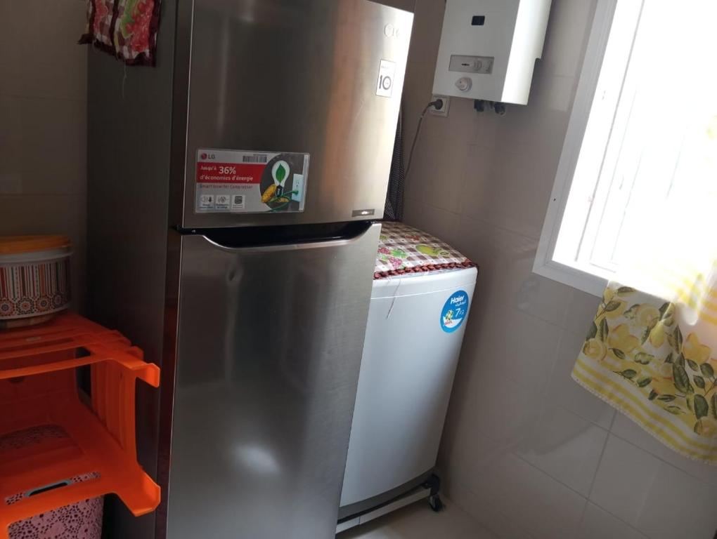 a refrigerator in a kitchen with a small freezer at Apparemment hay Adrar agadir à côté de carrefour in Agadir