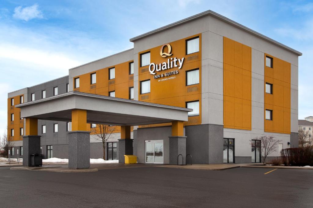 a office building with a company sign on it at Quality Inn & Suites Kingston in Kingston