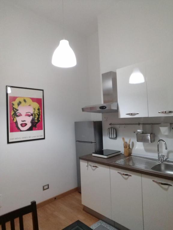 a kitchen with a sink and a refrigerator at Appartamento Aurora Pro in Altamura