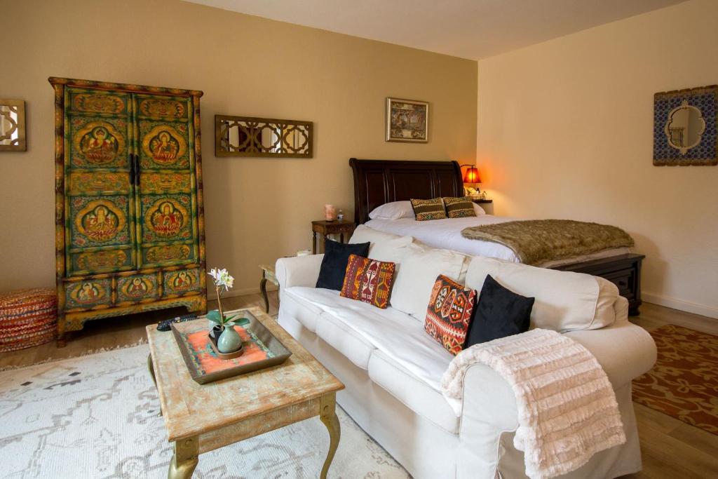 a living room with a couch and a bed at Cozy Sedona Casita with Private Courtyard & Stargazing Hot Tub in Sedona