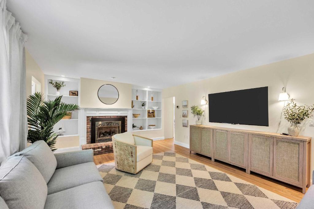 a living room with a couch and a television at Secluded 3-Bedroom Retreat in Falmouth in Falmouth