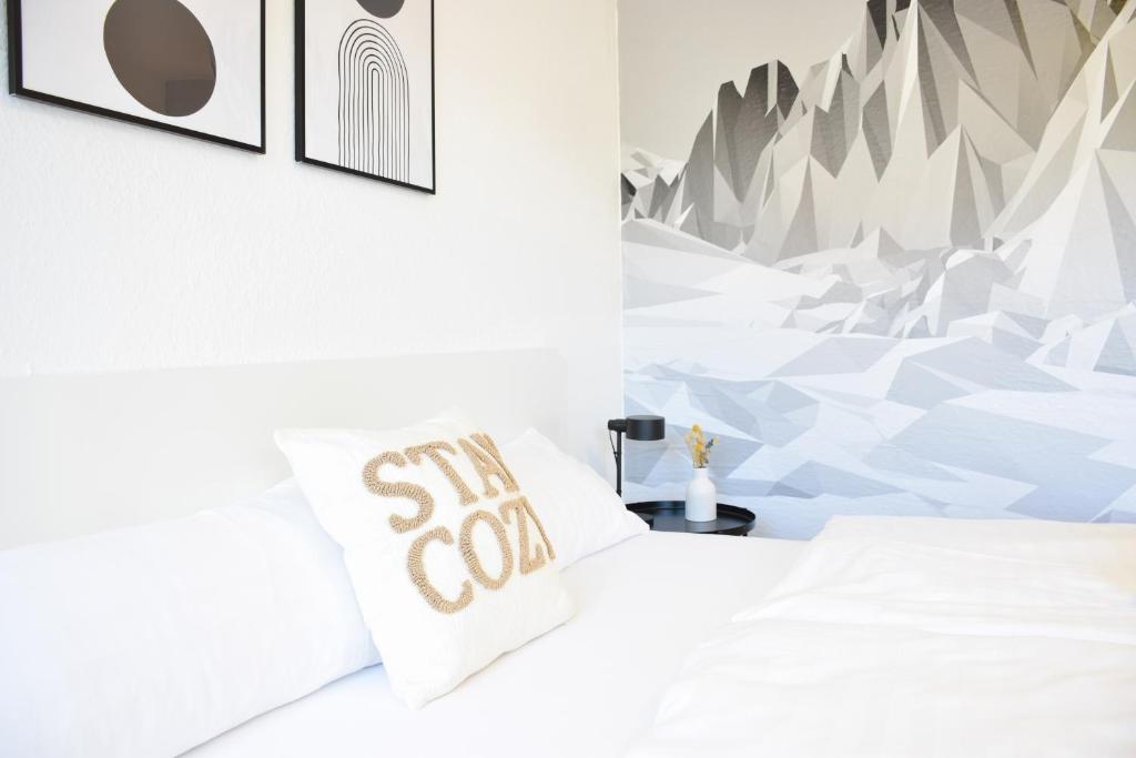 a bedroom with a bed with a snow mountain mural at stycoz - Modern studio - Central in Kempten
