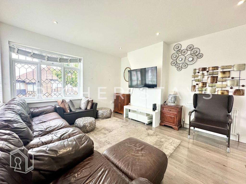 a living room with a couch and a television at Modern Classic 3-Bedroom Flat in The Hyde