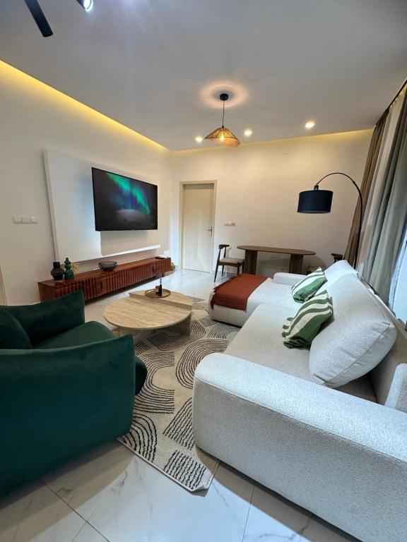 a living room with a couch and a flat screen tv at La brise Marine in Lomé