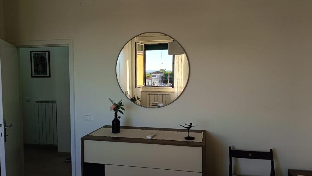 a bathroom with a sink and a mirror on a wall at Casa Verina at the station in Castiglion Fiorentino