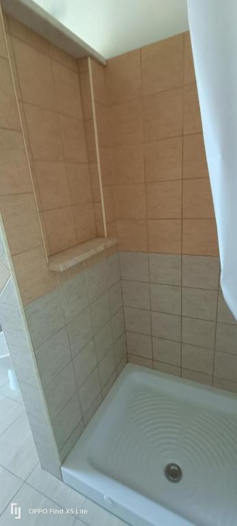 a bathroom with a shower with a white tub at La casa di Erica in Sestu