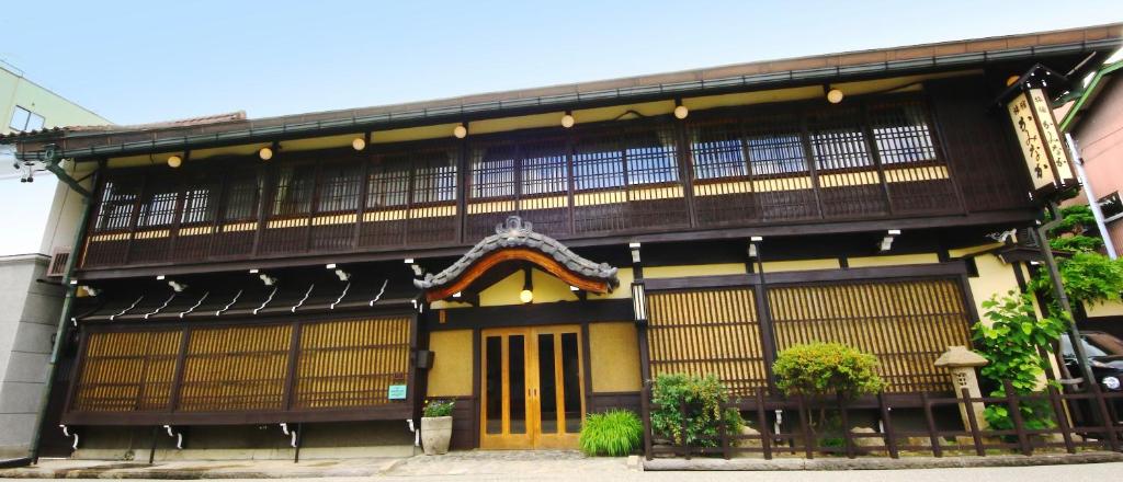 a building with an asian style building at Ryokan Kaminaka in Takayama