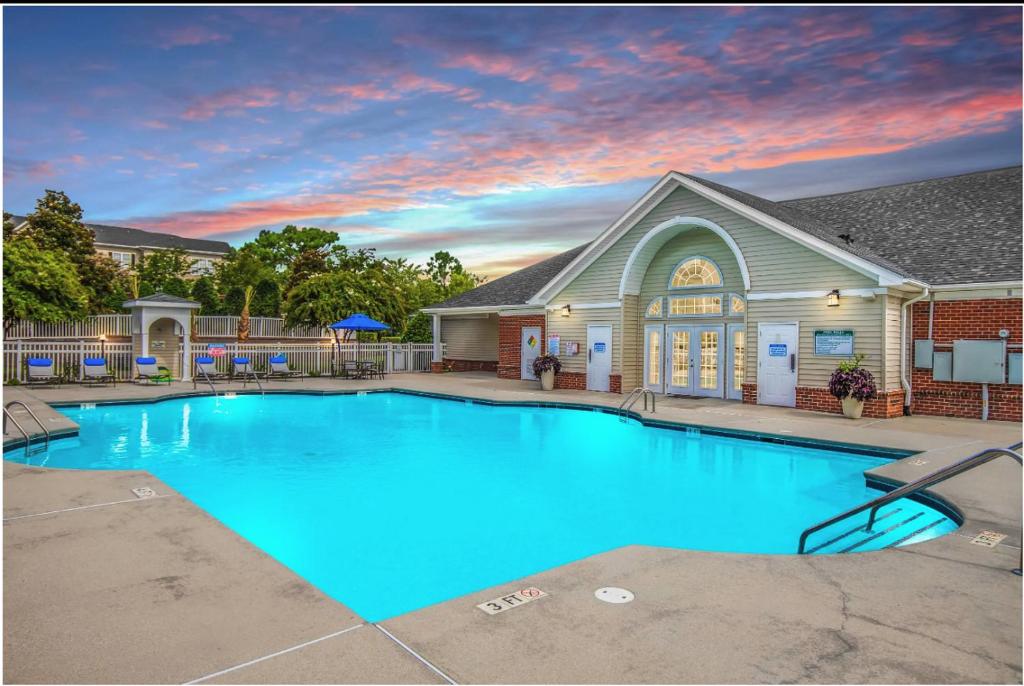 a large blue swimming pool in front of a house at Landing Bellingham Park - Wilmington in Wilmington