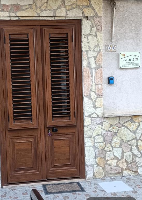 a wooden door on the side of a stone building at Casa di Lia in Montelepre