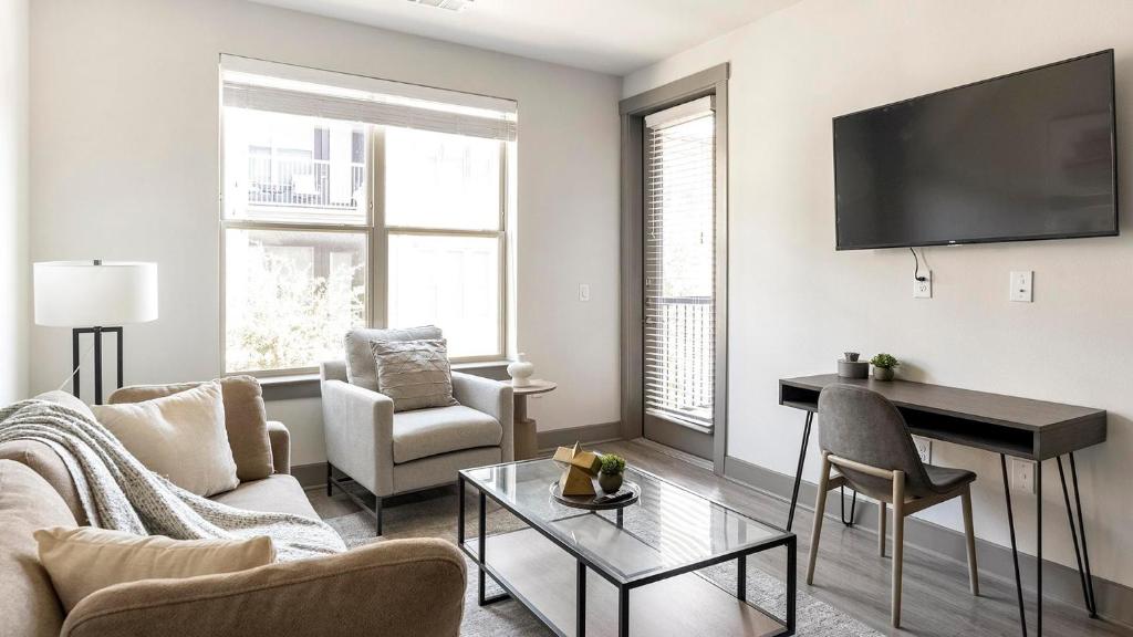 ein Wohnzimmer mit Couch und Tisch in der Unterkunft Fairview Apartments by Landing in McKinney