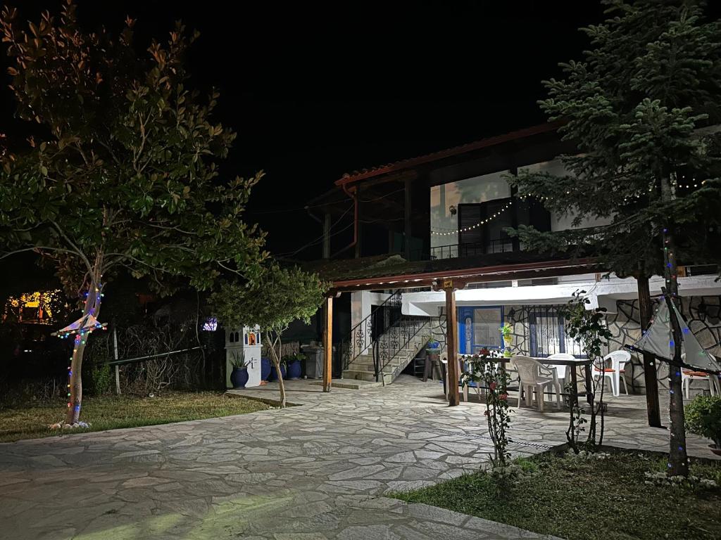 a house at night with a stone walkway at Erifyli in Nea Kallikrateia