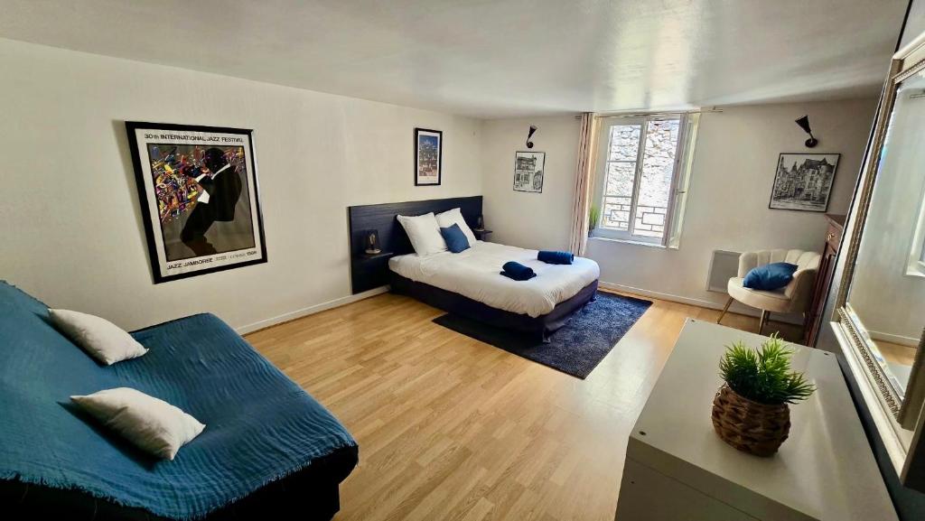 a bedroom with a bed and a couch in it at Maison de ville Le troubadour in Sarlat-la-Canéda