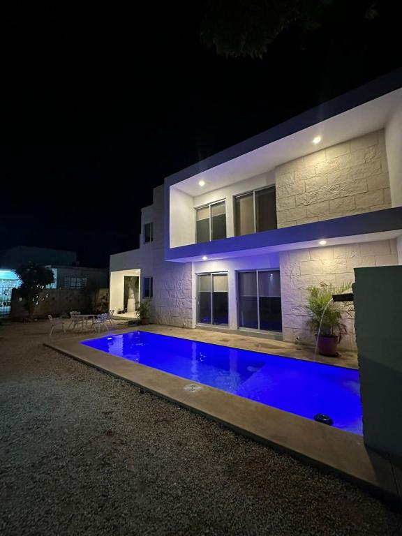 a house with a swimming pool at night at Casa D'Sauza's in Tekax de Álvaro Obregón