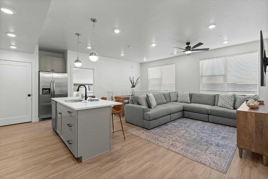 a kitchen and living room with a couch and a table at Cliffside Vista - Stay for 7 in Hurricane