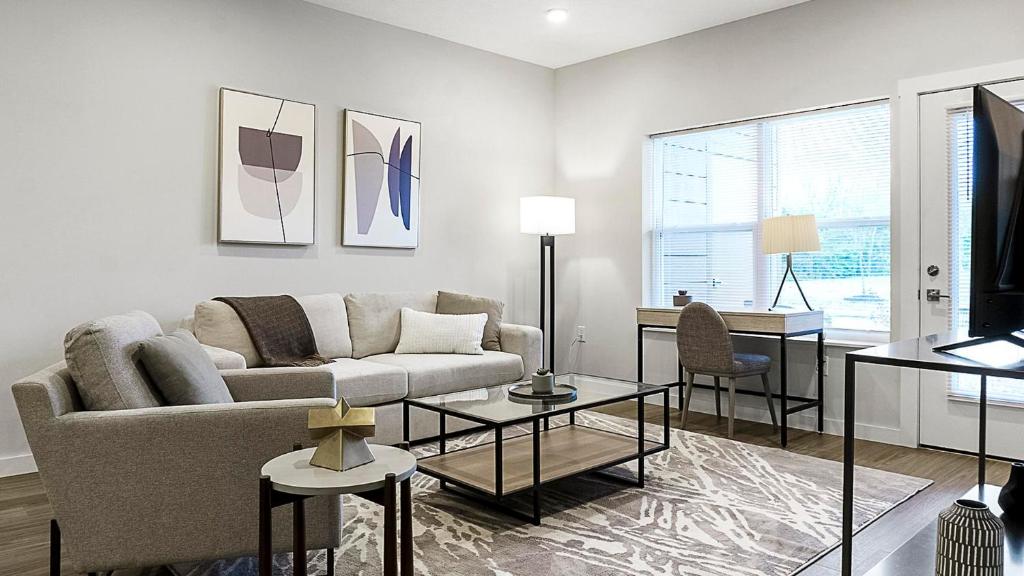 a living room with a couch and a table at Landing at The Landing - Indianapolis in Indianapolis