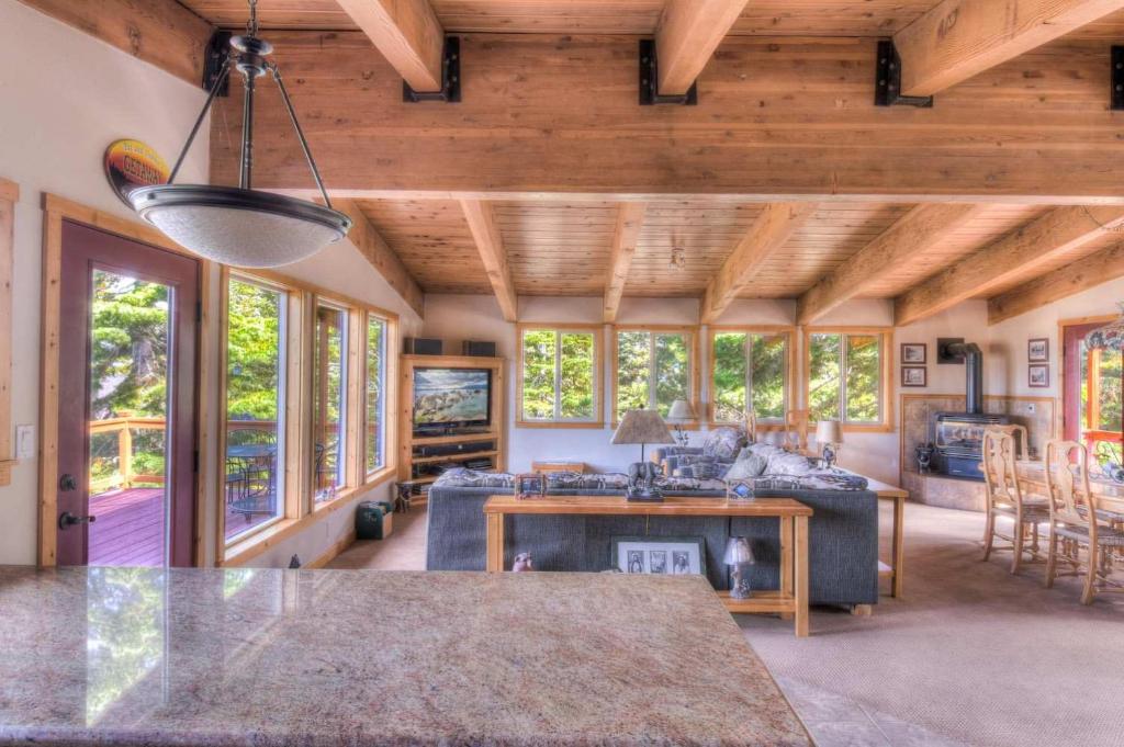 a living room with a couch and a table at Chamberland Getaway Lake Views with Deck in Tahoma