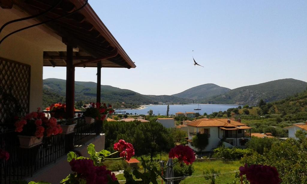 a view of a lake from a house with flowers at El Capitan in Porto Koufo