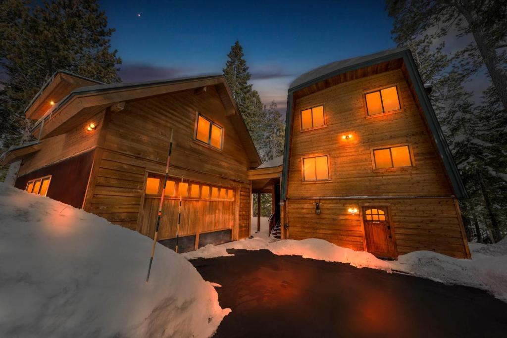 a log cabin in the snow at night at Tahoe City Retreat - For 8 in Tahoe City