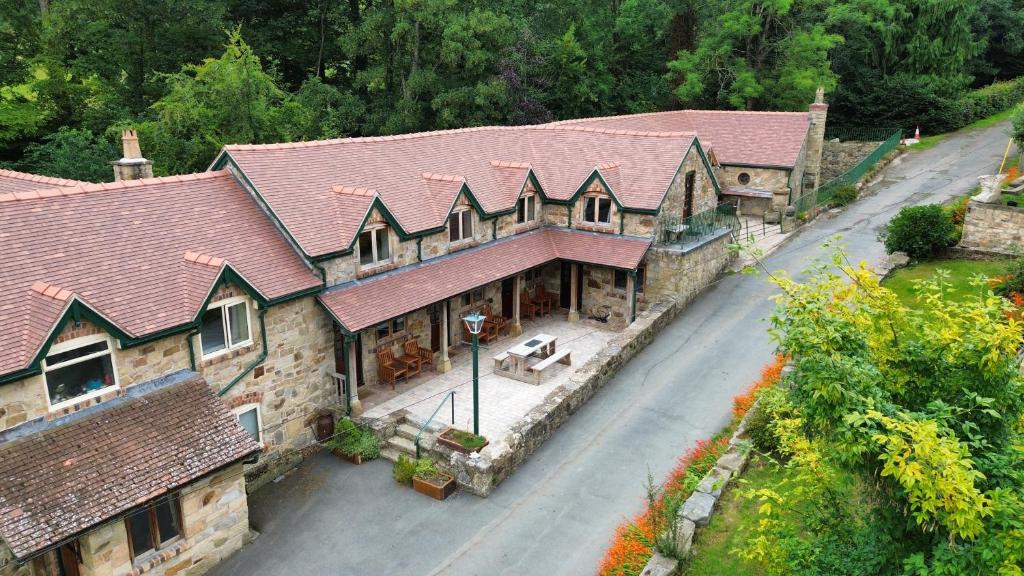an overhead view of a large house with a street at Nant Ucha Farm Holiday Cottages near Llangollen in Acrefair