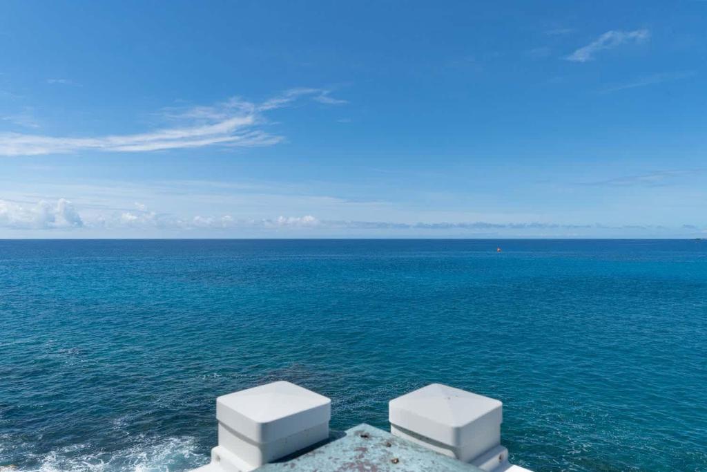 a view of the ocean with white objects in the water at Oceanfront Vintage Retreat in Kailua-Kona in Kailua-Kona