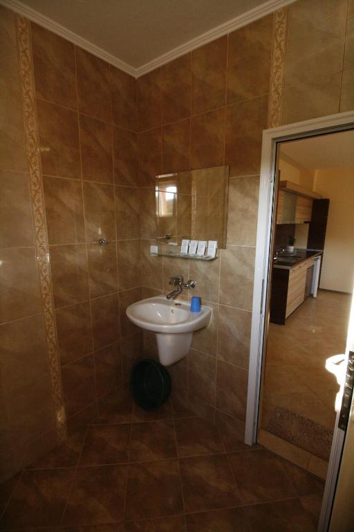 a bathroom with a white sink in a room at Hotel Marant in Sozopol