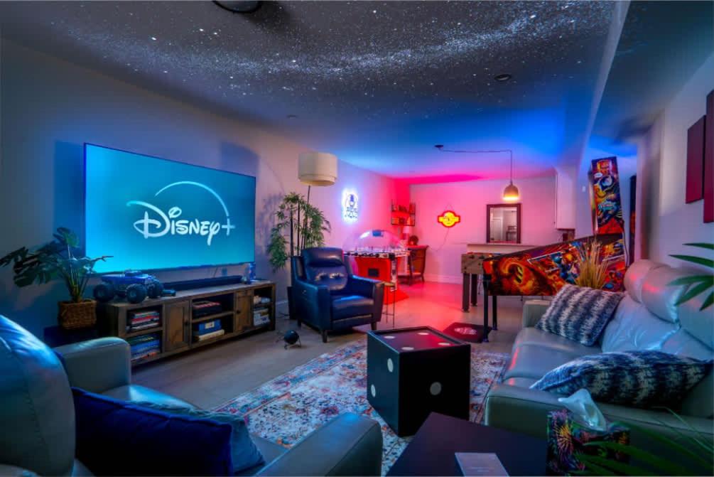 a living room with a couch and a tv at In-Home Arcade Hot Tub Golf Close to Beach in Old Orchard Beach