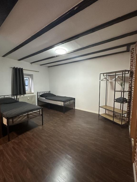 an empty room with two beds and a shelf at Apartment Oberhausen in Oberhausen