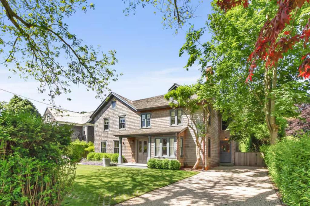 an exterior view of a house with a yard at Wells Villa by Rove Travel - Family Home with Pool & Sauna in Amagansett