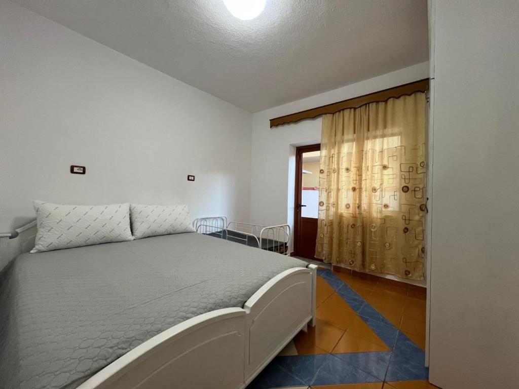 une chambre avec un lit et une fenêtre dans l'établissement Minga Apartments, à Pogradec